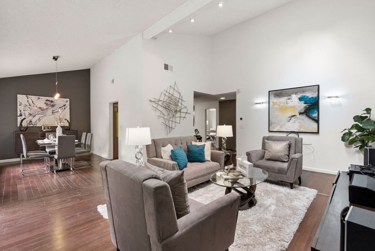 Living and dining room with vaulted ceiling and hardwood floors