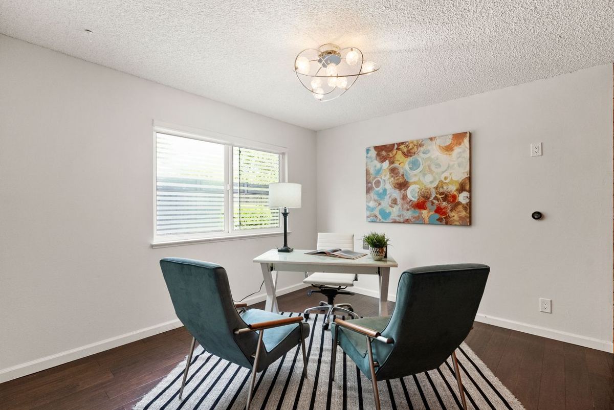 Home office with two lounge chairs and abstract art
